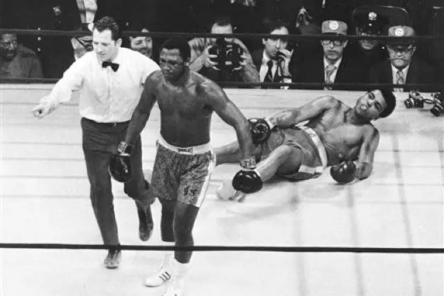 Joe Frazier is directed to a corner by referee Arthur Marcante after Frazier knocked down Muhammad Ali during the 15th round of the title bout in Madison Square Garden in New York